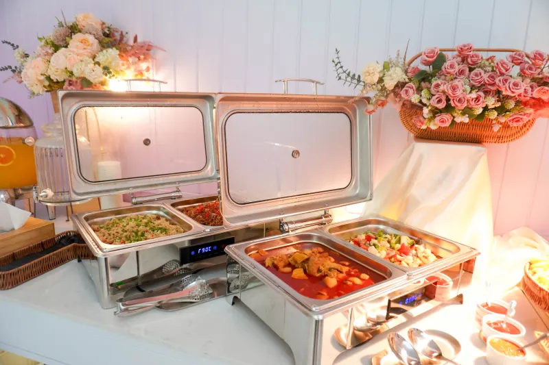 Warm buffet dishes ready on the party room counter at UFOREA Penang