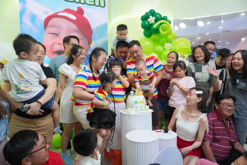 A UFOREA Penang host leading the cake moment at a first birthday party