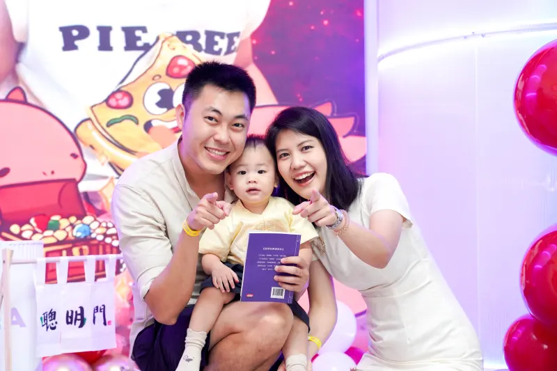 A family posing for the in-house photographer at a UFOREA Penang birthday