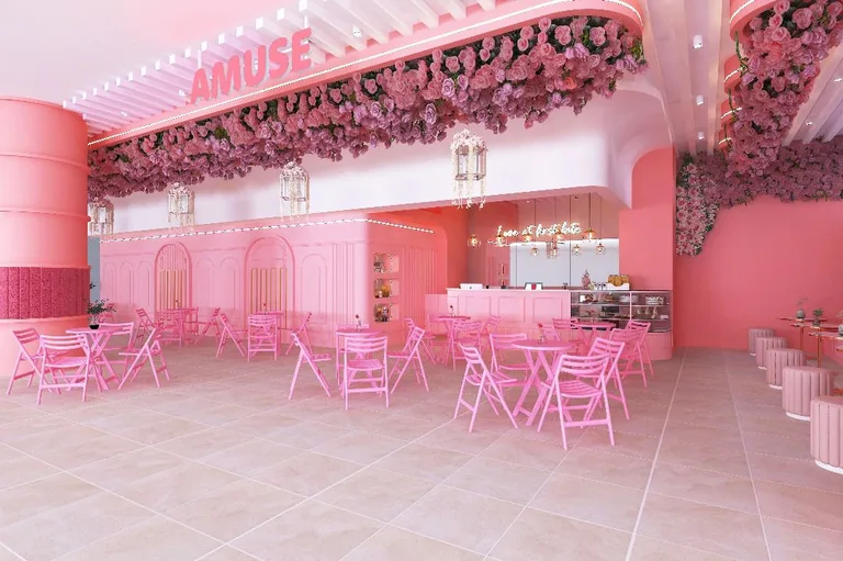 Amuse Café by UFOREA — the rose-covered pink café beside the entrance with tables and a dessert counter