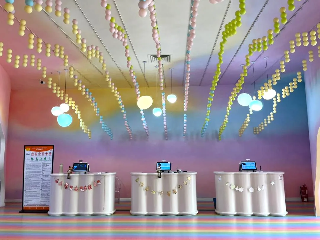 The pastel check-in counters under balloon garlands at UFOREA Penang