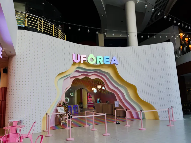 The rainbow entrance arch and check-in area at UFOREA Penang