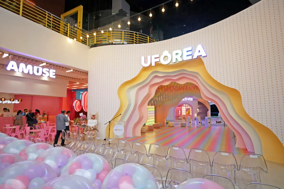 The pastel rainbow arc entrance of UFOREA Penang set up for an event, beside the Amuse café
