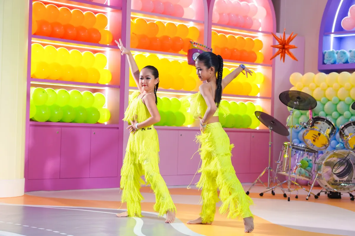 Two young dancers performing on stage at a UFOREA Penang school holiday event