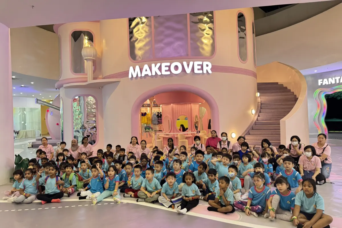 A kindergarten class seated for a group photo at the Makeover castle inside UFOREA Penang