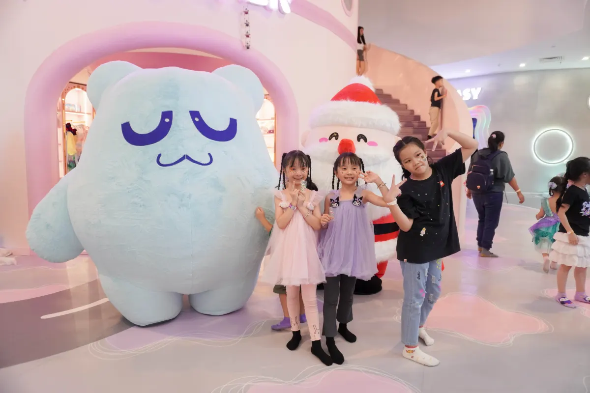 Children posing with the UFOREA bear mascot and Santa during a Christmas event at UFOREA Penang