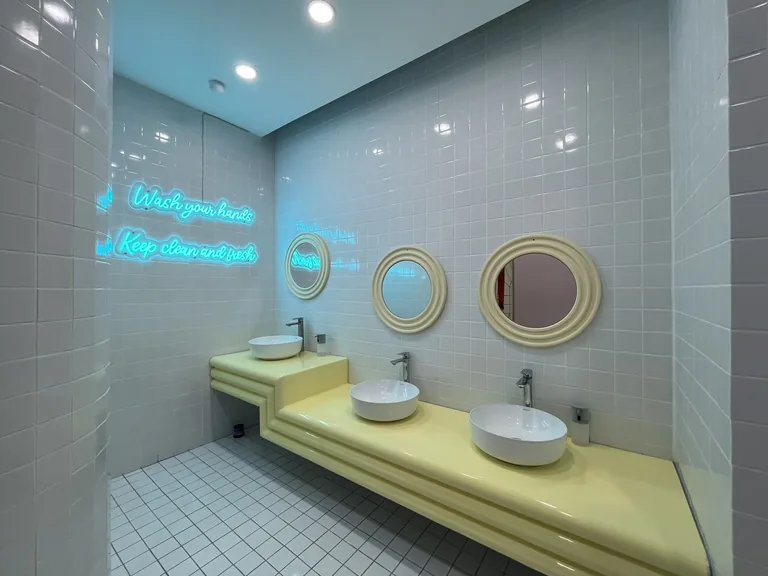 The blue washroom sinks and hand-washing sign at UFOREA Penang