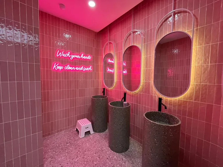 The pink washroom sinks and hand-washing sign at UFOREA Penang