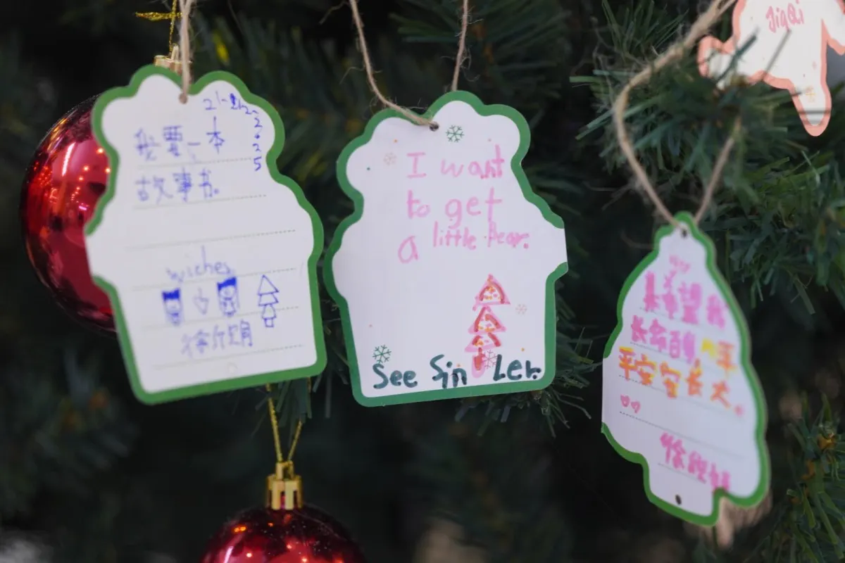 Handwritten wish cards hanging on the Christmas wishing tree at UFOREA Penang