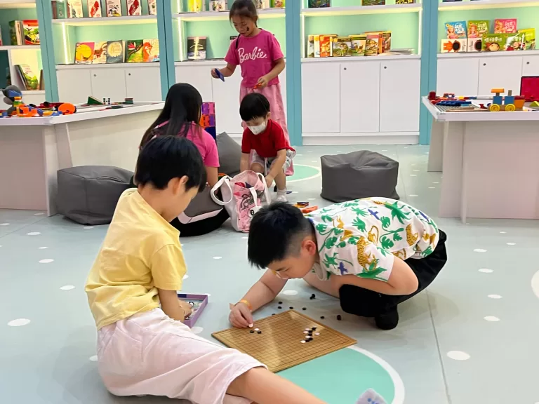 Children resting on a mushroom cap inside UFOREA's Little Paradise